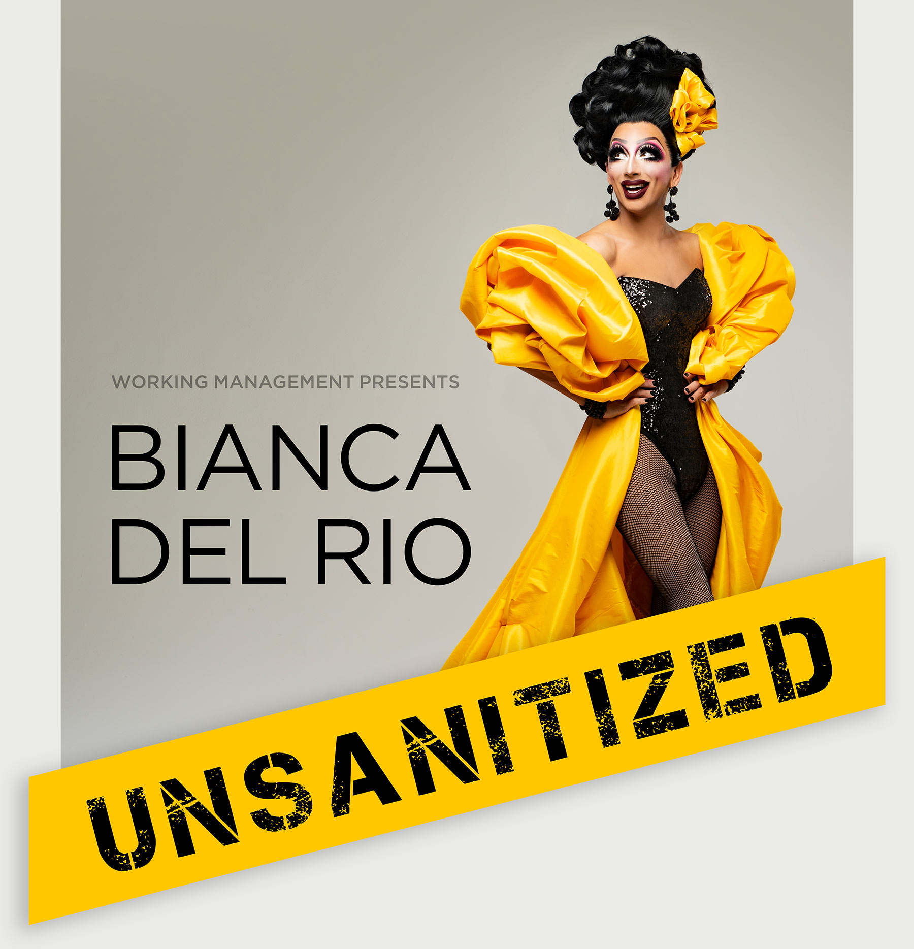 Bianca Del Rio wearing a black dress with bright yellow plastic draped coat, with large UNSANITIZED word placed over top