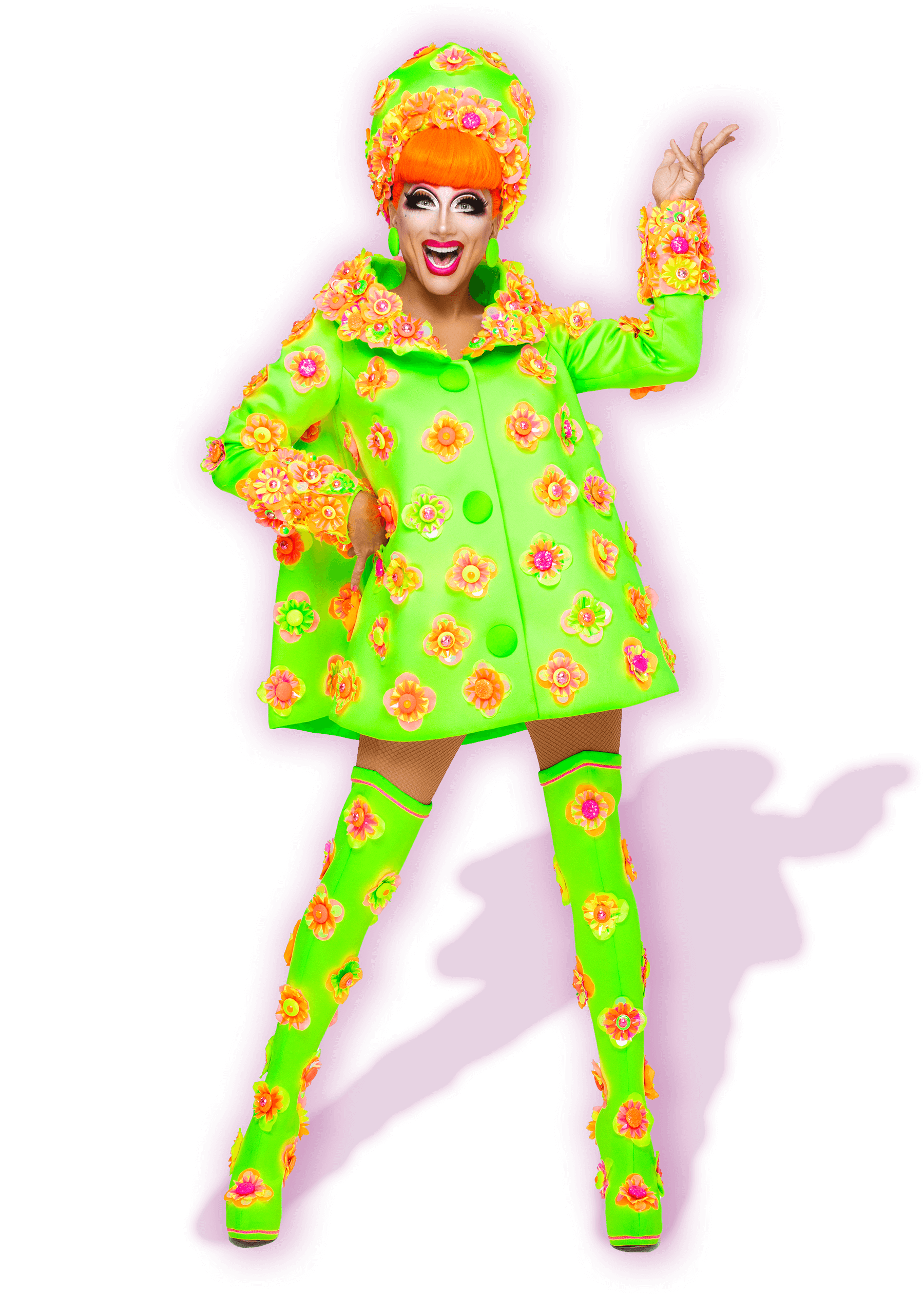 Photo of Bianca Del Rio wearing a neon green dress with bright orange flower detailing. She is wearing a fluoro orange wig and smiling.